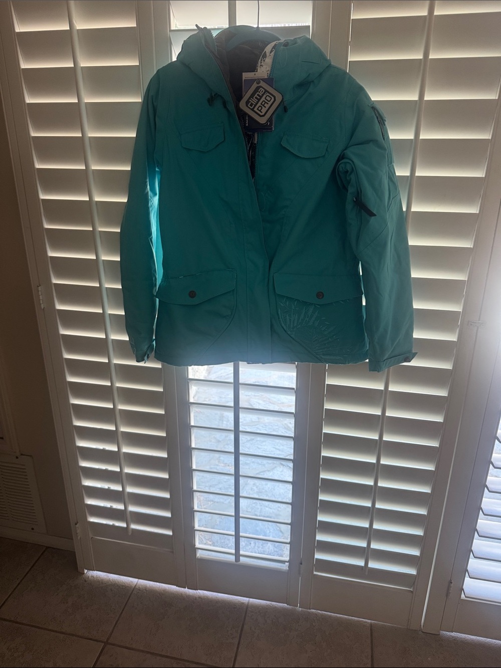 Teal Hooded Puffer Jacket by Salomon